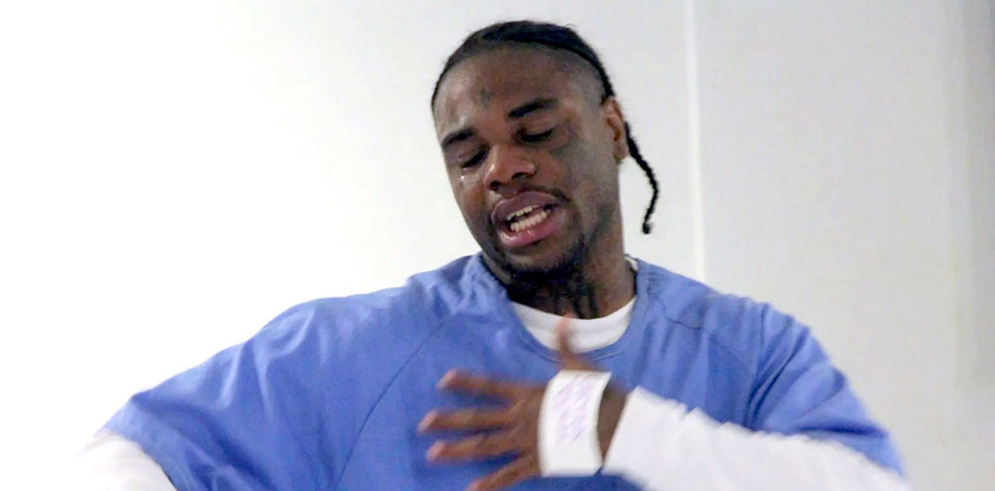 African American incarcerated male reciting poetry passionately while crying